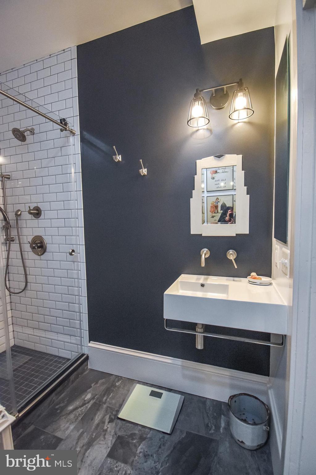 1830 Columbia Road Northwest Washington, DC 20009 - Photo 21 of 46 a bathroom with a sink and a mirror