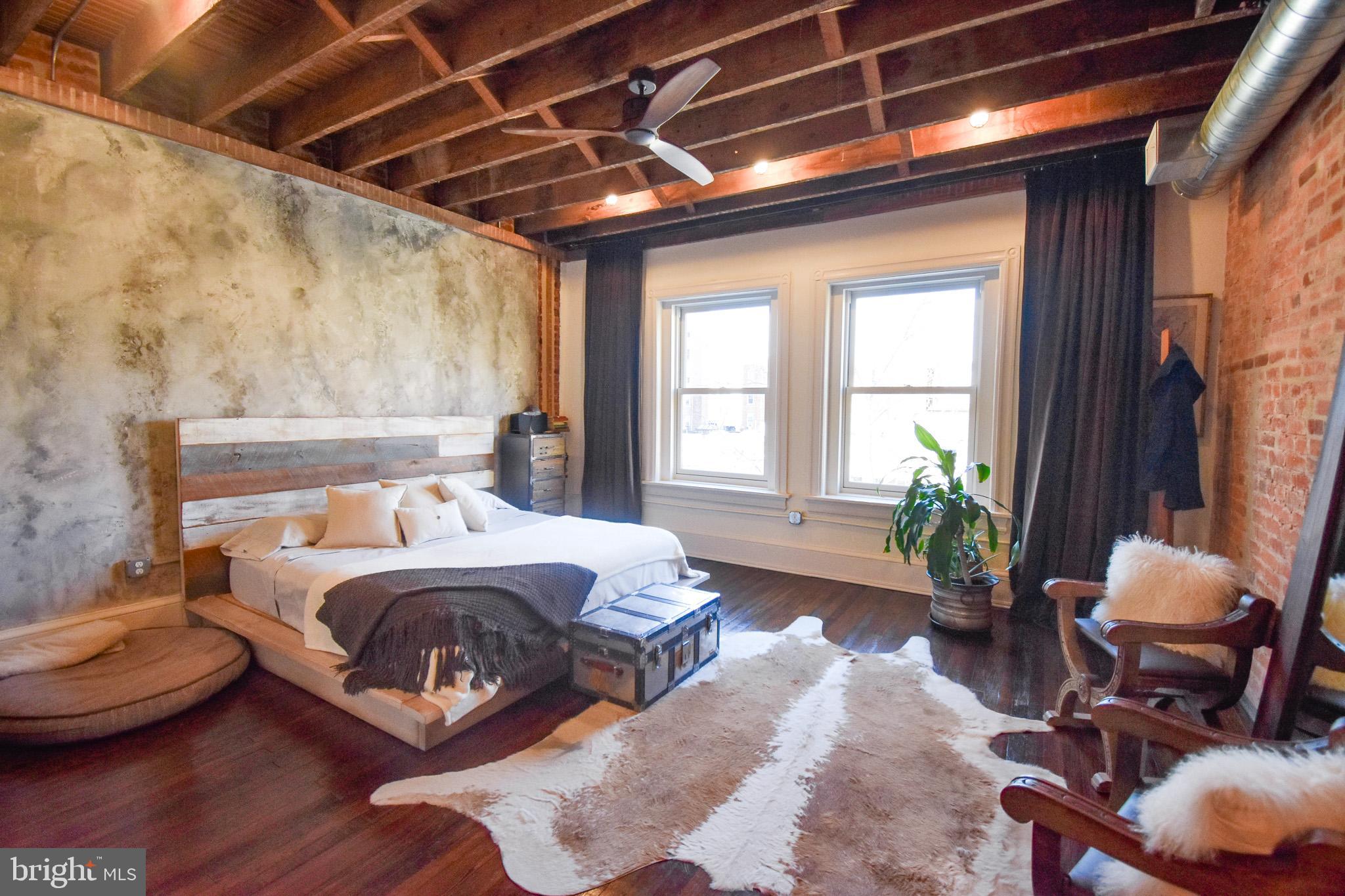 1830 Columbia Road Northwest Washington, DC 20009 - Photo 24 of 46 a bedroom with a bed chair and window