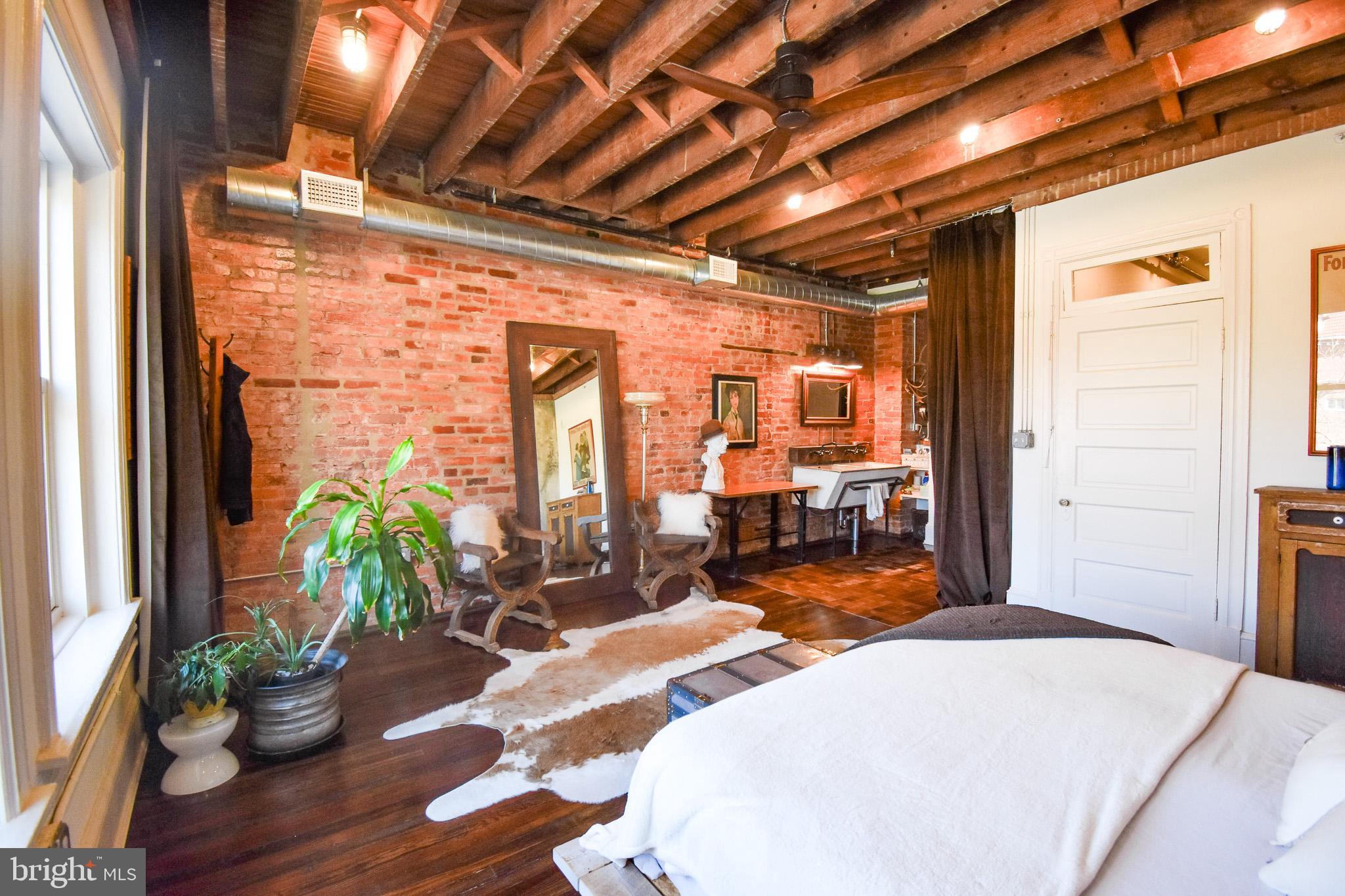 1830 Columbia Road Northwest Washington, DC 20009 - Photo 25 of 46 a bedroom with furniture and wooden floor