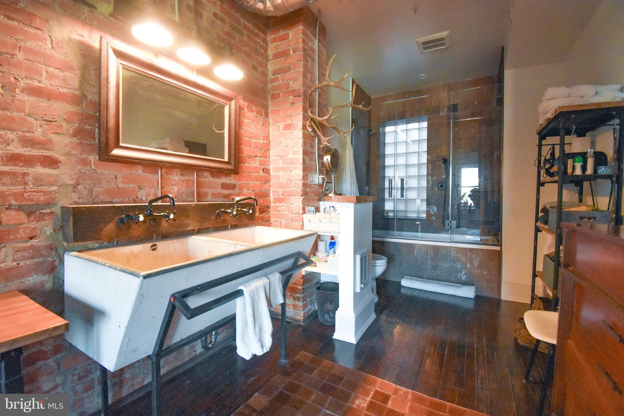 1830 Columbia Road Northwest Washington, DC 20009 - Photo 27 of 46 a bathroom with a sink and a mirror