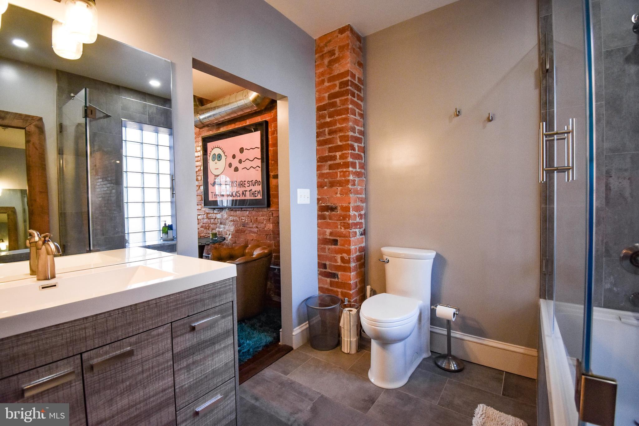1830 Columbia Road Northwest Washington, DC 20009 - Photo 33 of 46 a bathroom with a sink toilet and shower