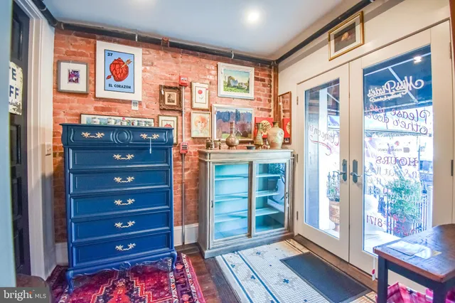 a living room with furniture and a book shelf