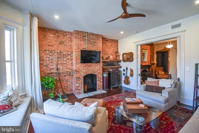 a living room with furniture and stairs