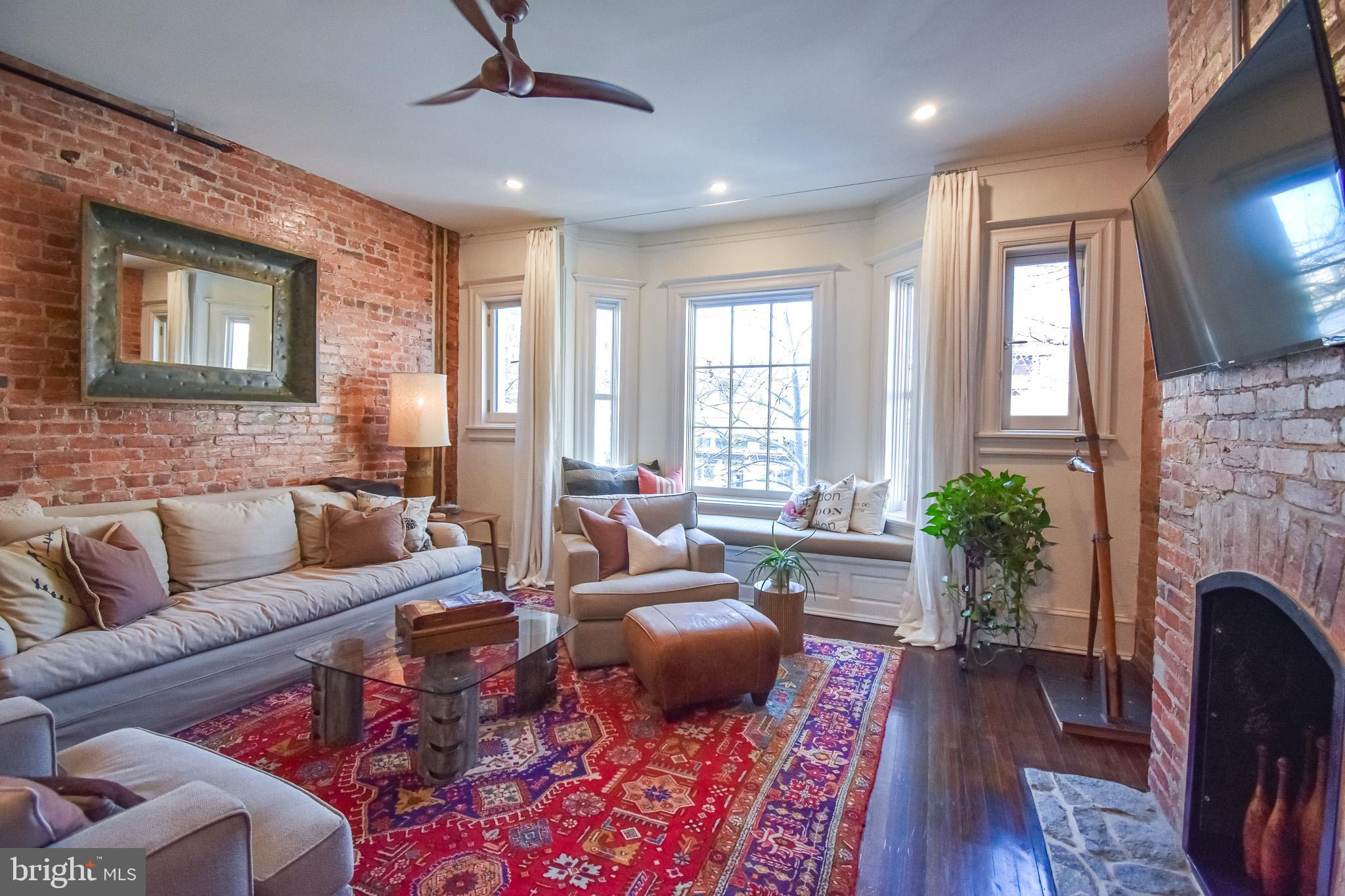 1830 Columbia Road Northwest Washington, DC 20009 - Photo 7 of 46 a living room with furniture fireplace and window