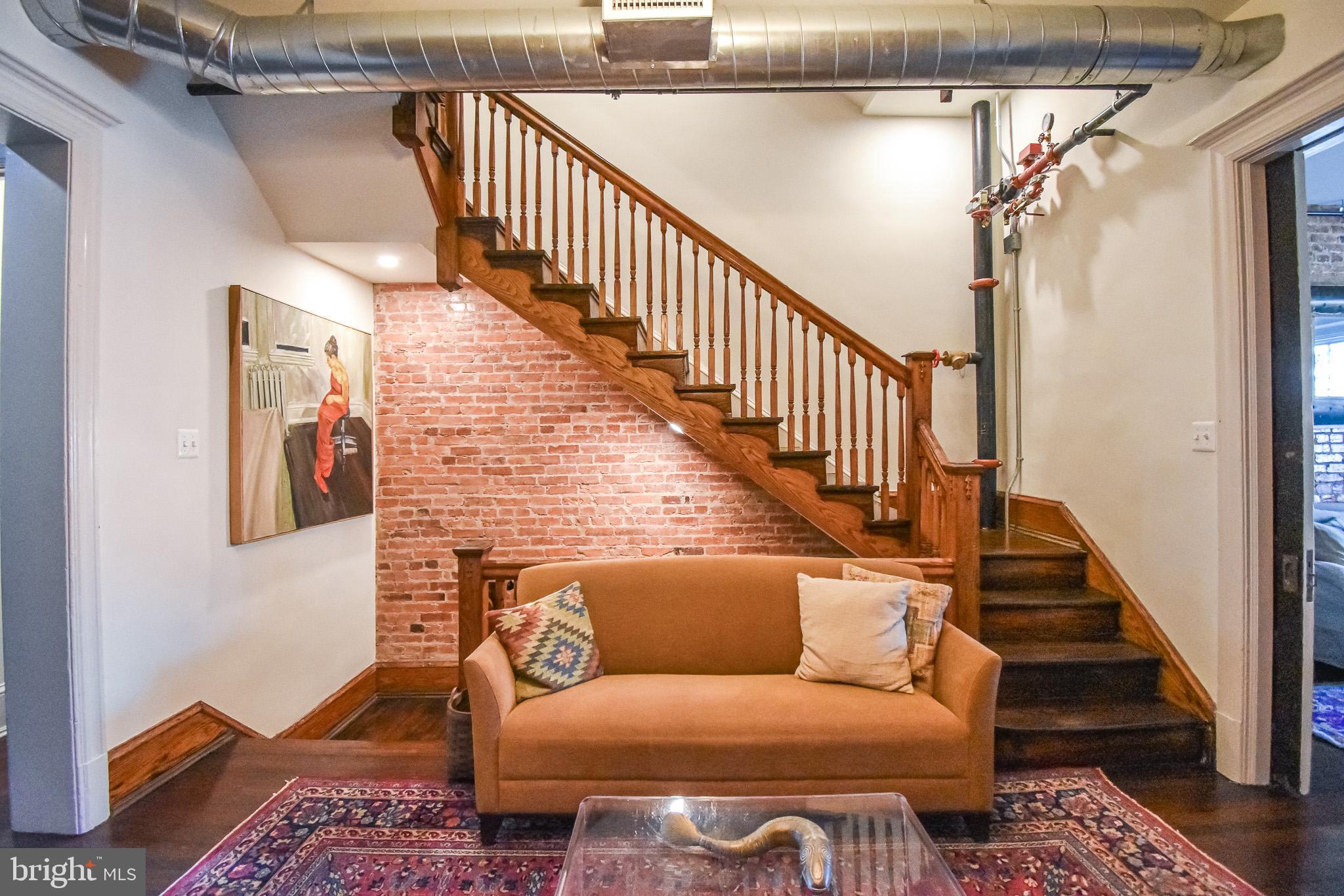 1830 Columbia Road Northwest Washington, DC 20009 - Photo 8 of 46 a living room with furniture and stairs