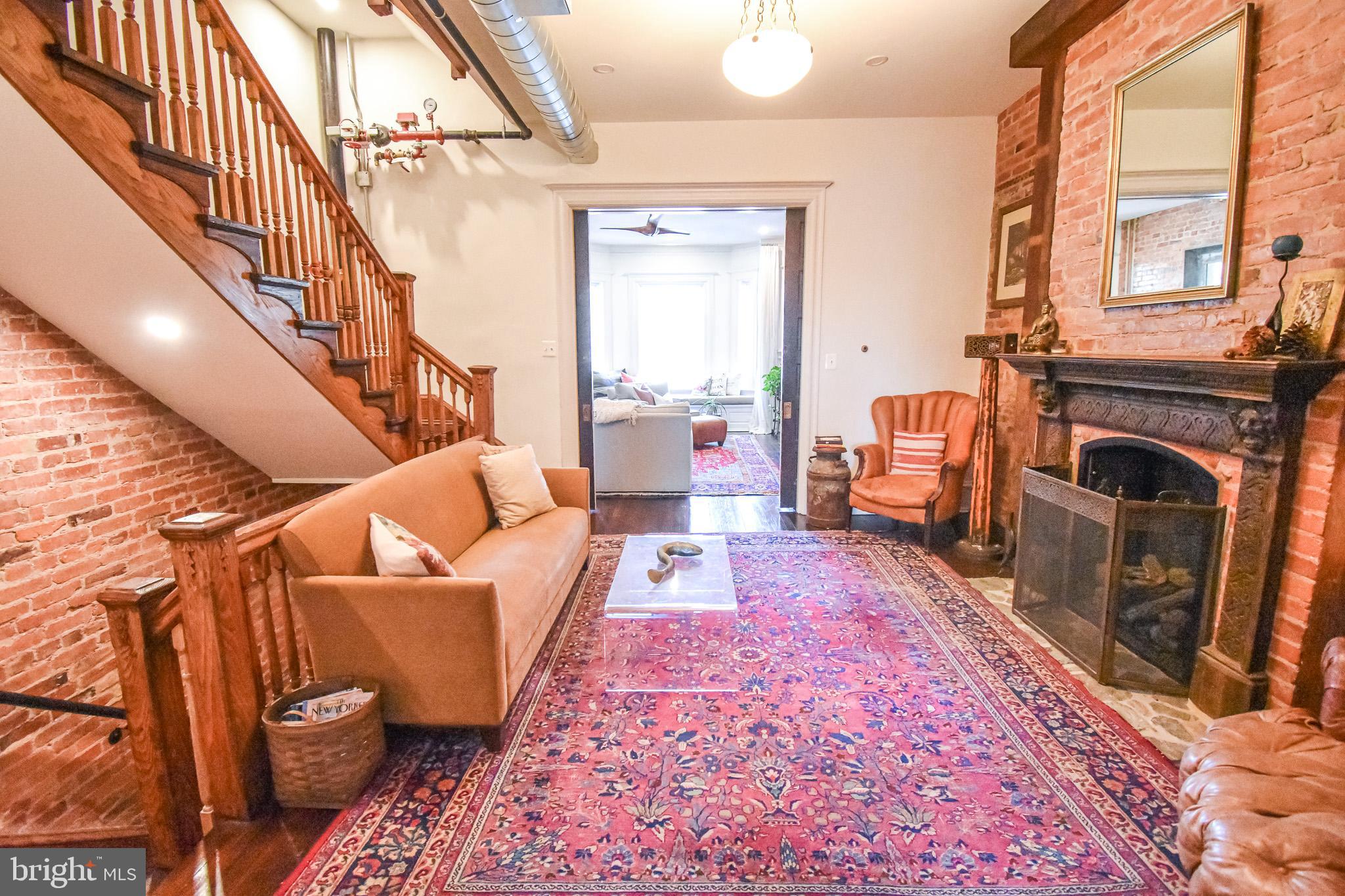 1830 Columbia Road Northwest Washington, DC 20009 - Photo 10 of 46 a living room with furniture and a fireplace