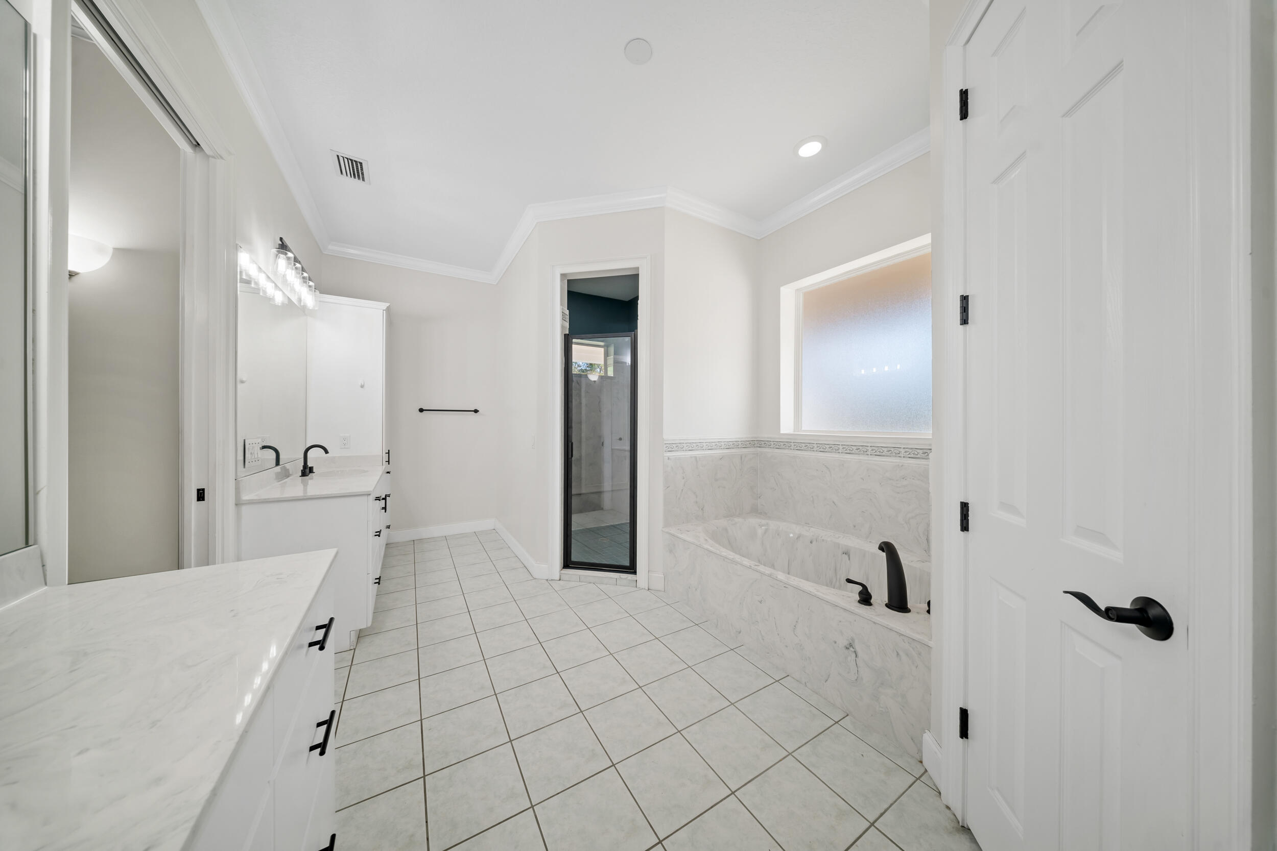 8686 Andrews Avenue Fort Pierce, FL 34945 - Photo 27 of 76 a spacious bathroom with a shower and a tub