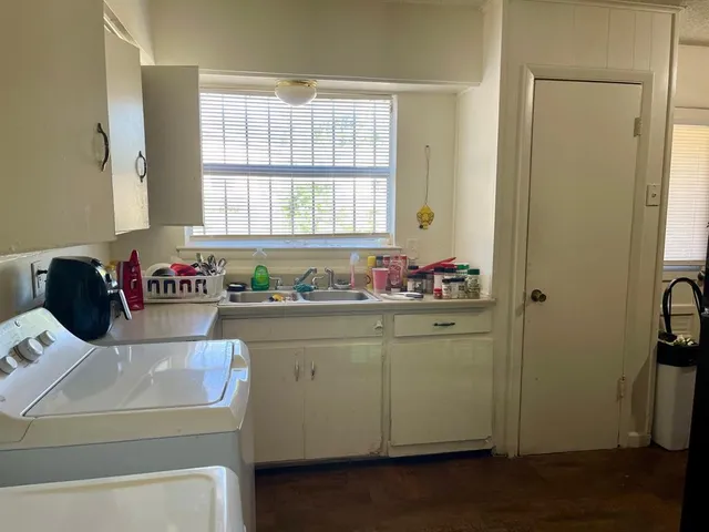 a kitchen with sink refrigerator and window