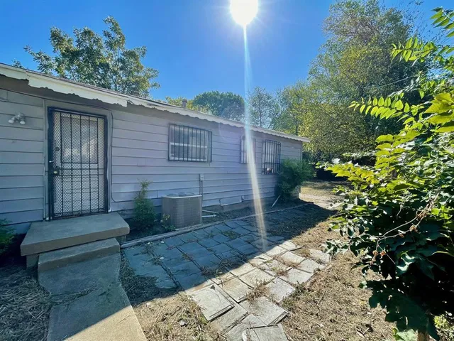 a view of a backyard with plants and a patio