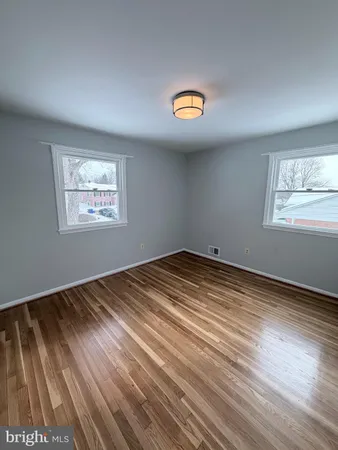 wooden floor in an empty room and a window