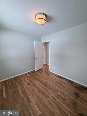 a view of an empty room and wooden floor