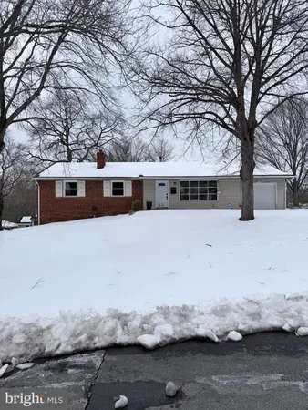 a view of a house with a yard covered with snow in the background