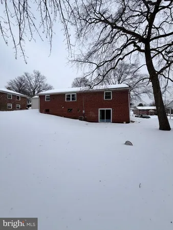 a backyard of a house with trees and covered with wooden fence