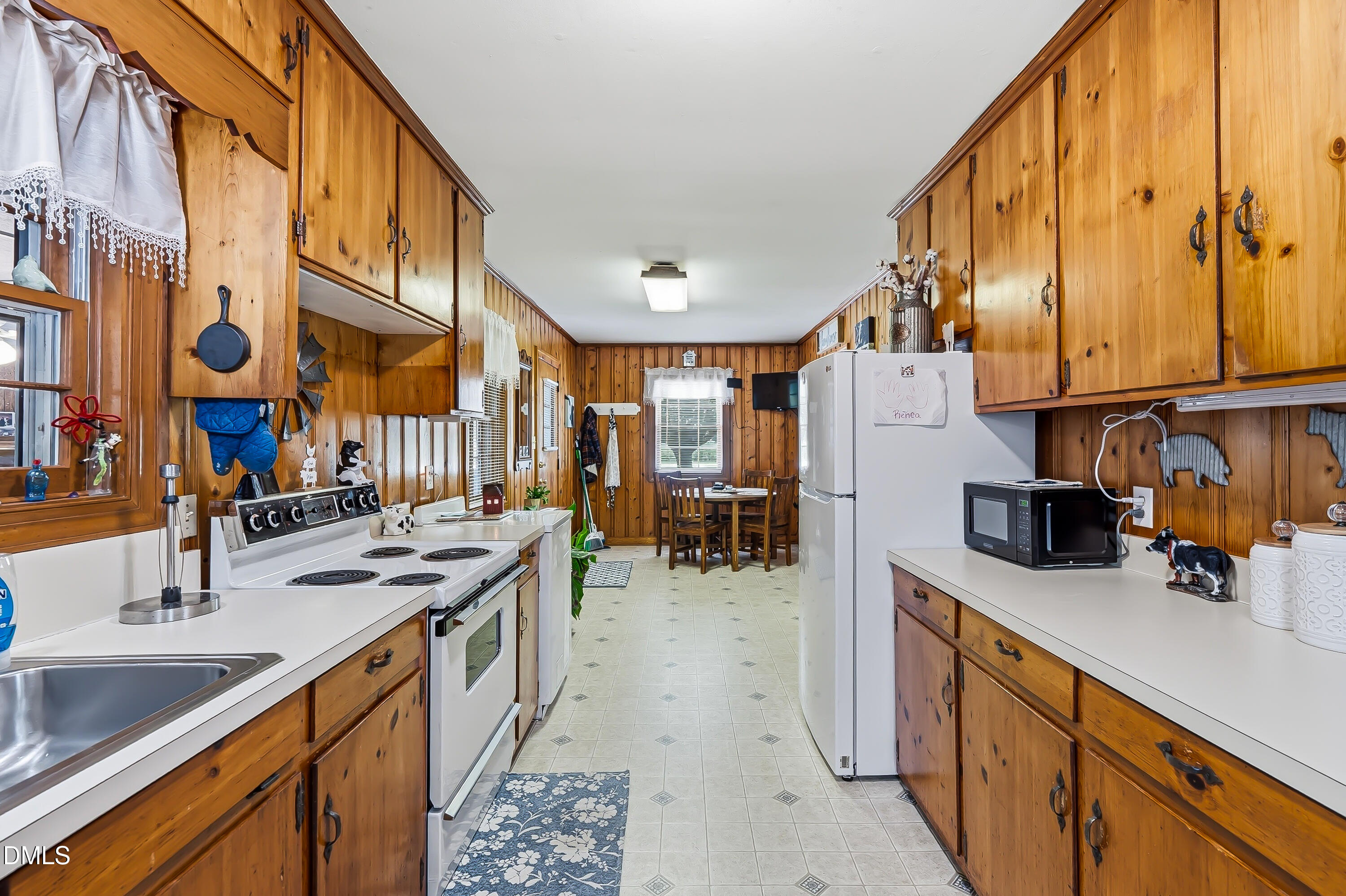 4967 Highway 581 Spring Hope, NC 27882 - Photo 26 of 44 a kitchen with stainless steel appliances a sink stove and cabinets