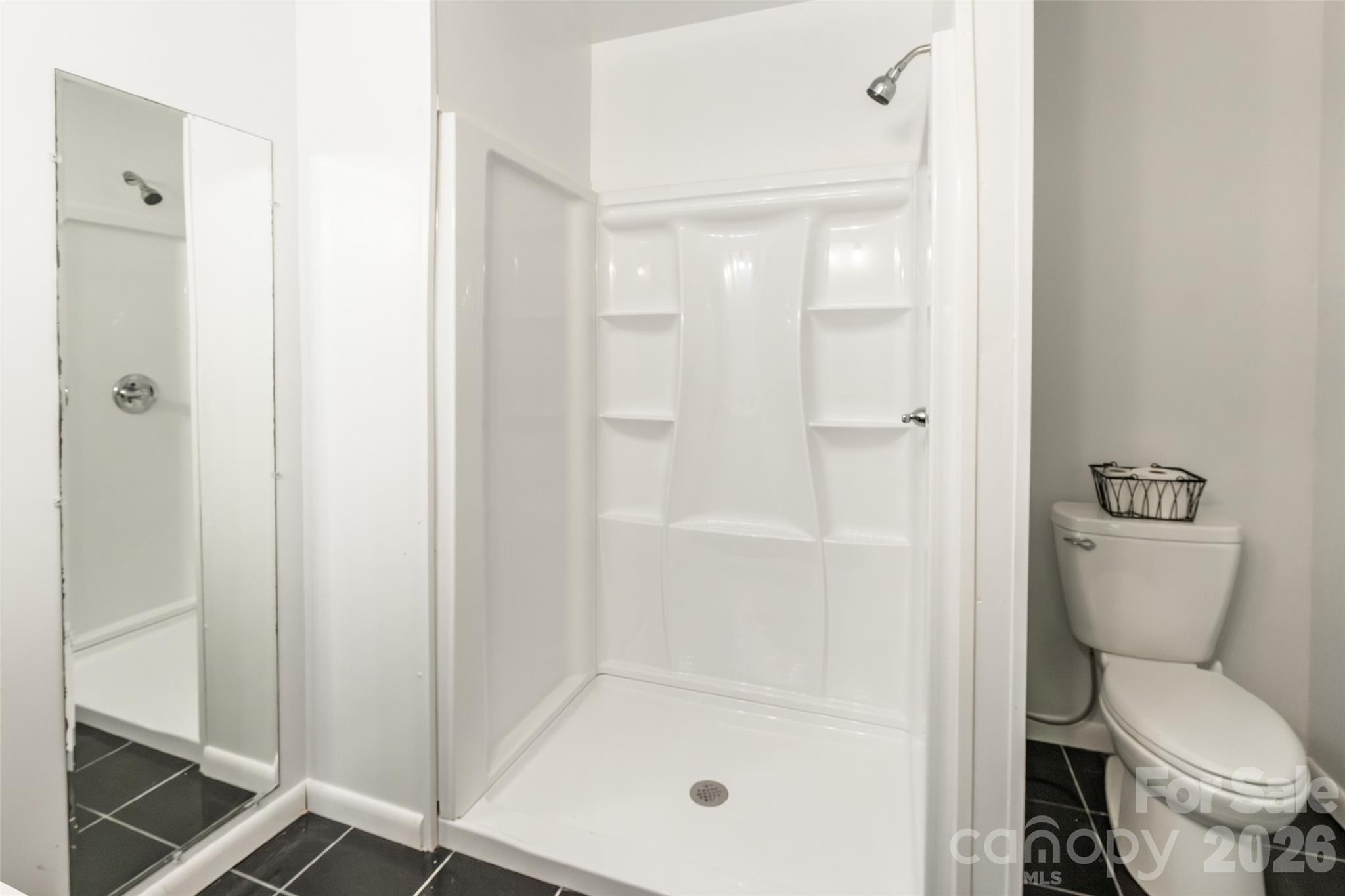 513 Mountainbrook Road Lancaster, SC 29720 - Photo 30 of 48 a bathroom with a shower a toilet and a sink
