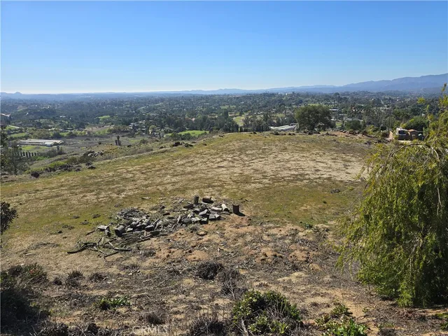 a view of a dirt road and a building