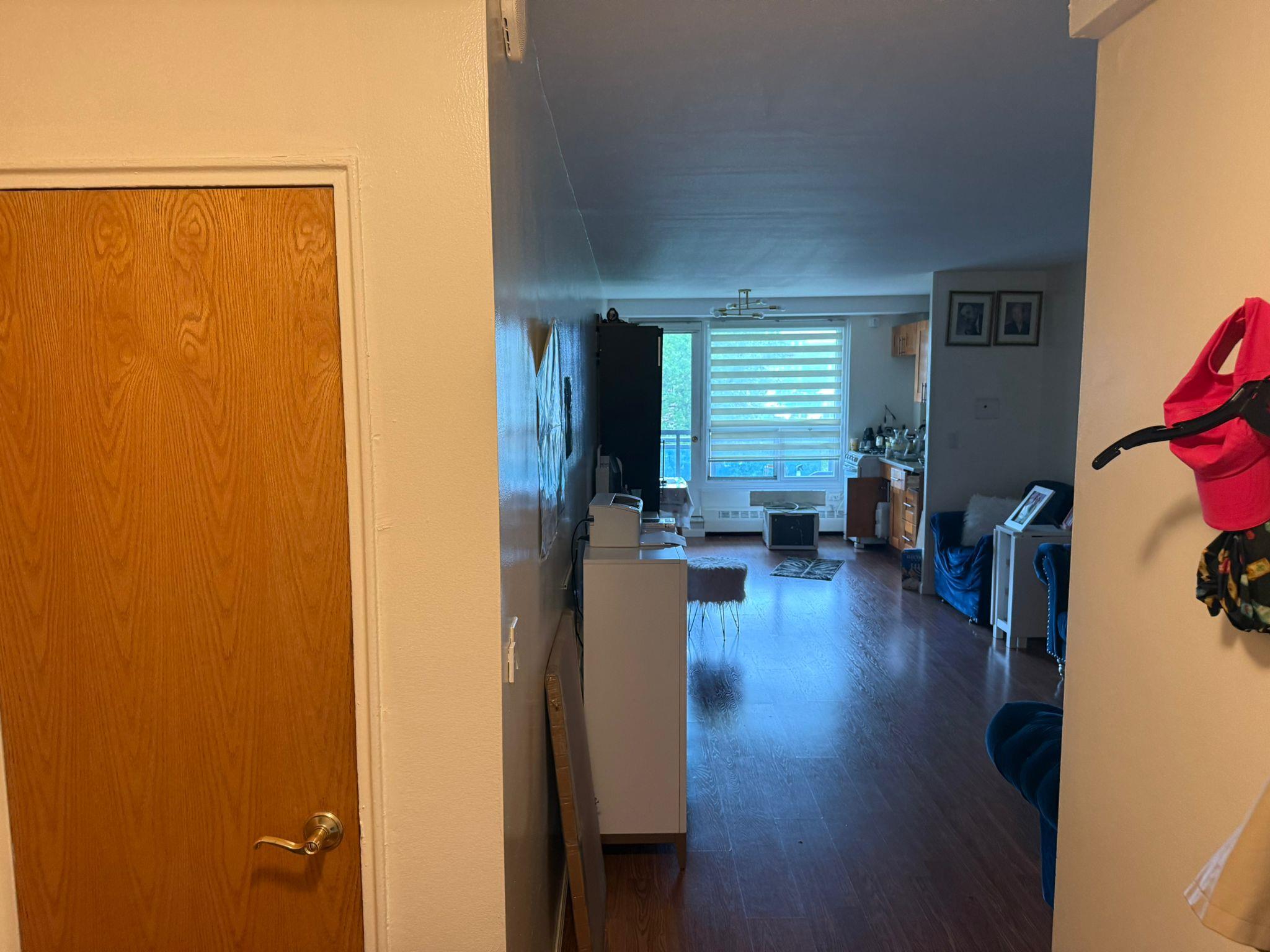 97-37 63rd Road, Unit 5N Queens, NY 11374 - Photo 10 of 17 Hallway with wood finished floors