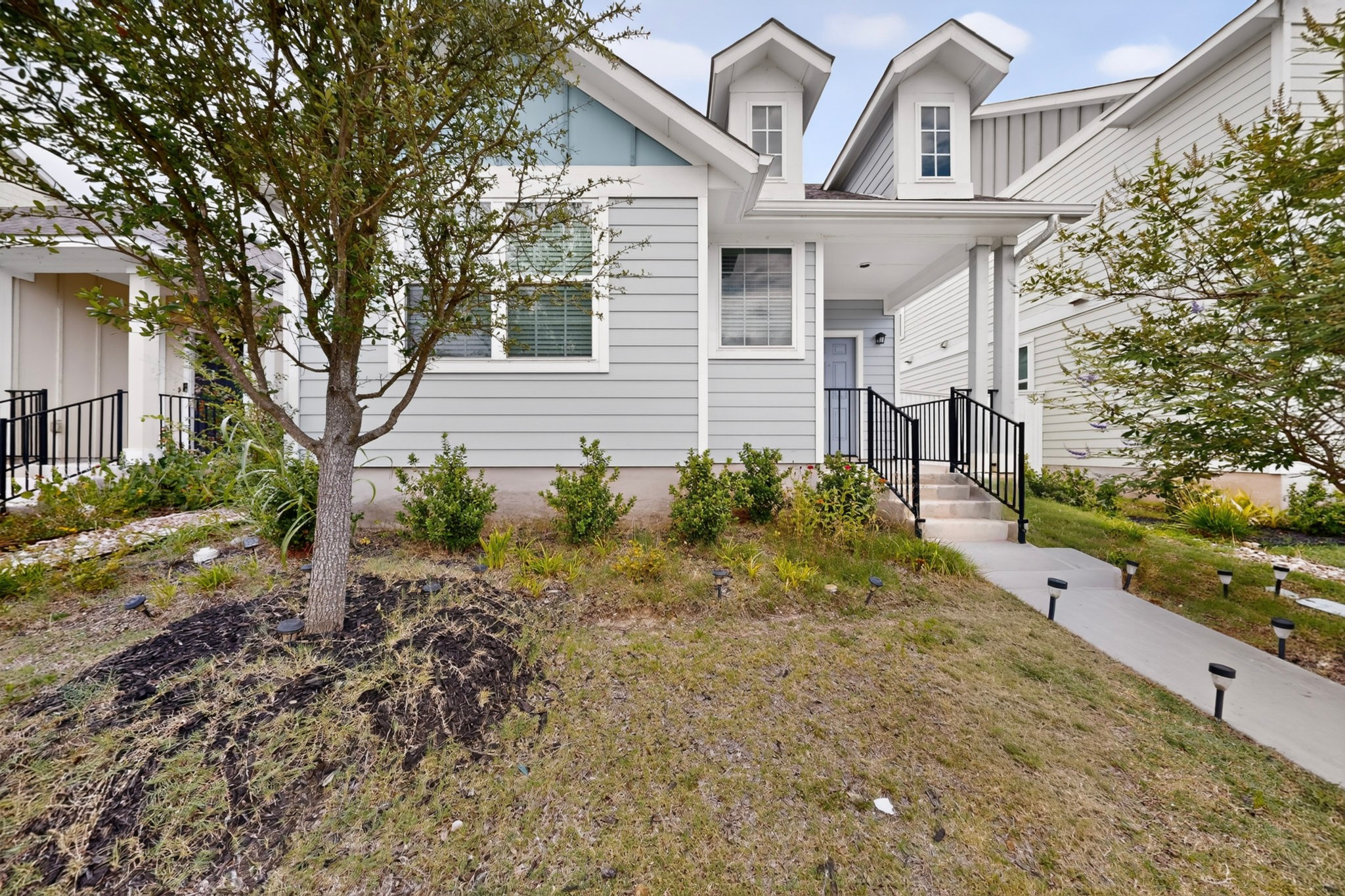 116 Appleberry Lane Elgin, TX 78621 - Photo 2 of 35 A welcoming front facade showcases a neat walkway leading to the entrance of this modern residence.