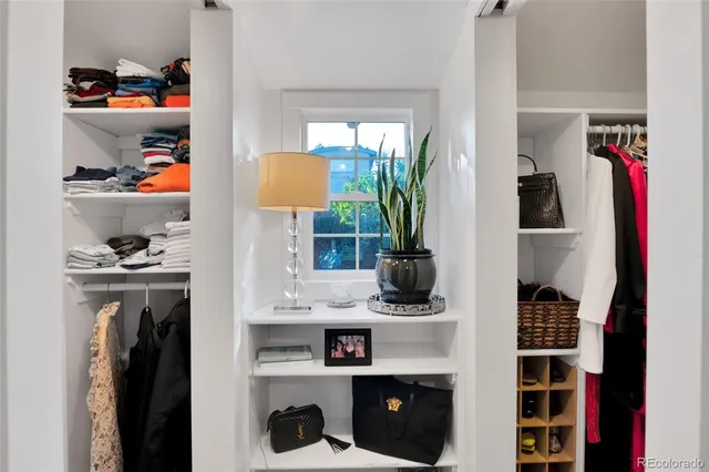 a view of walk in closet with clothes and shoes