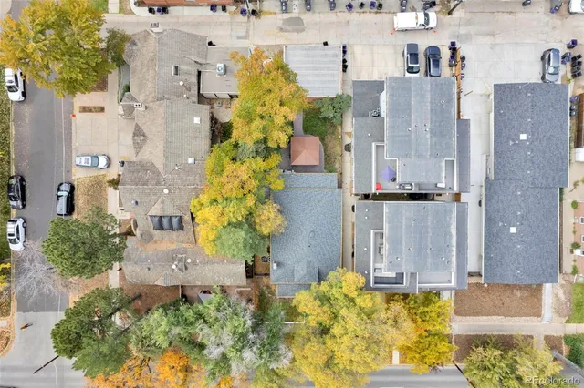 an aerial view of residential houses with outdoor space and swimming pool