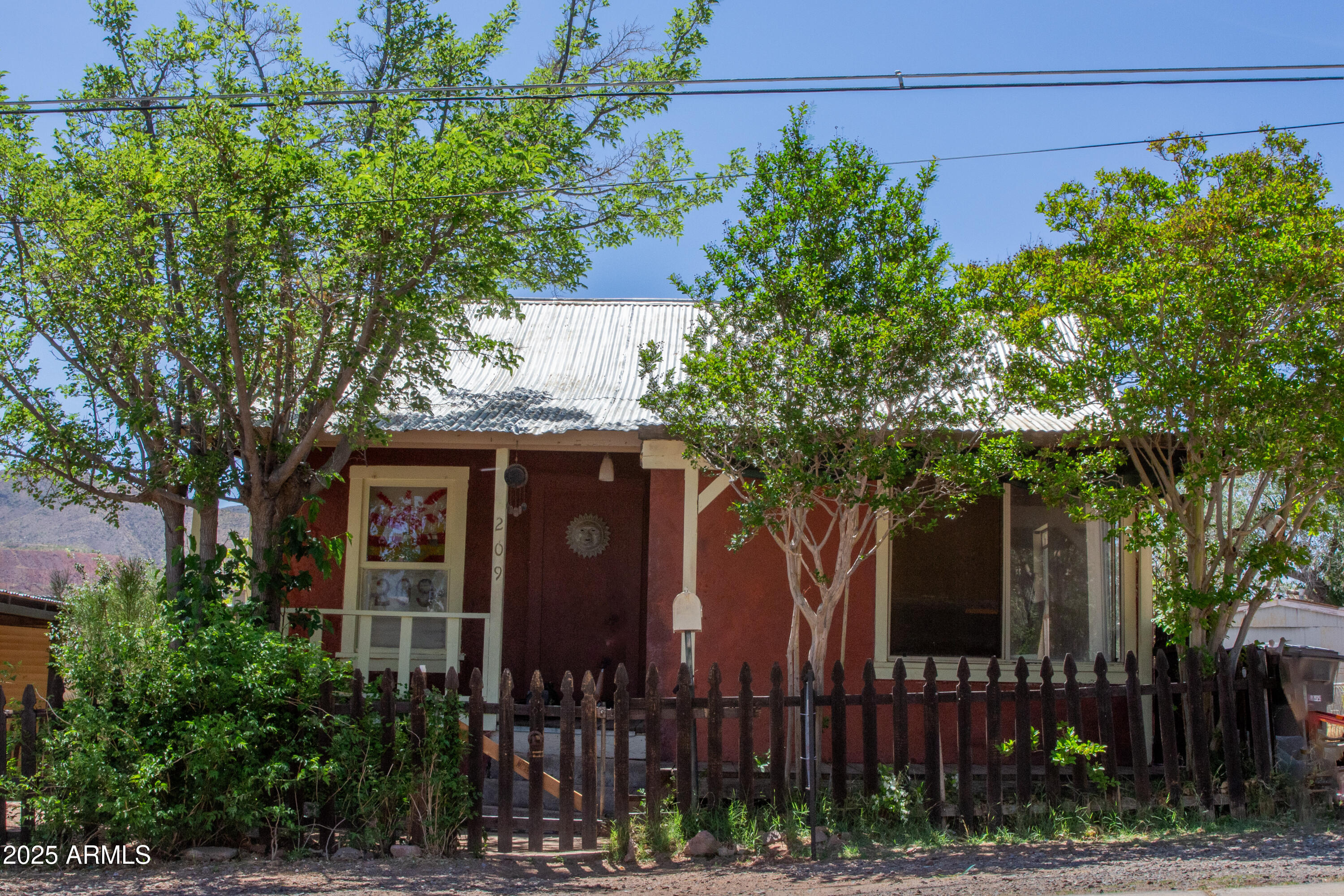 front view of a house with a tree