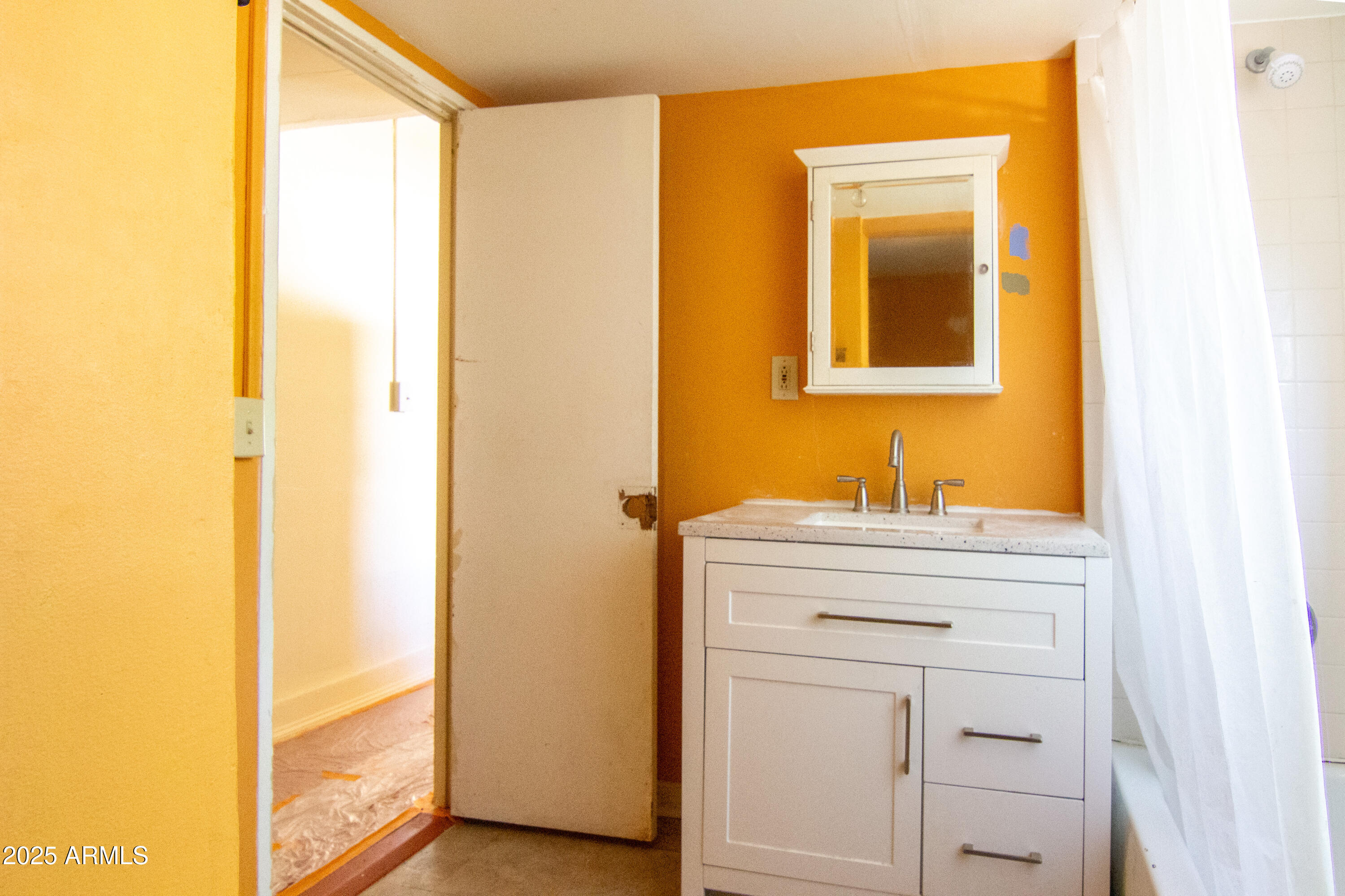 209 A Street Bisbee, AZ 85603 - Photo 10 of 23 a bathroom with a sink and a mirror