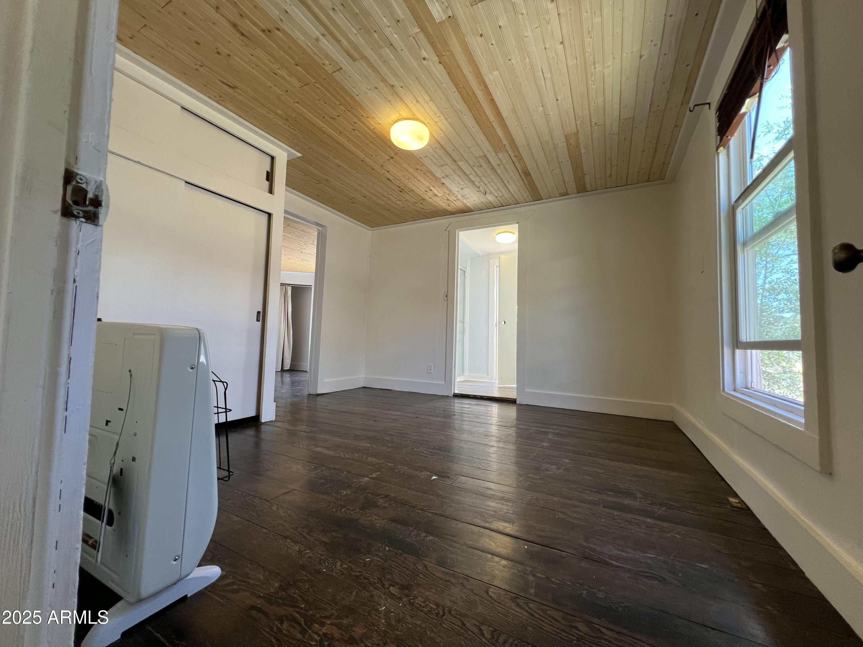 209 A Street Bisbee, AZ 85603 - Photo 11 of 23 a view of an empty room with wooden floor and a window