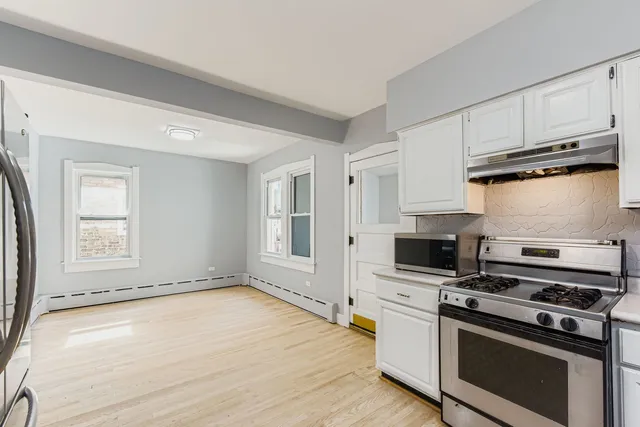 a kitchen with a stove a sink and a refrigerator