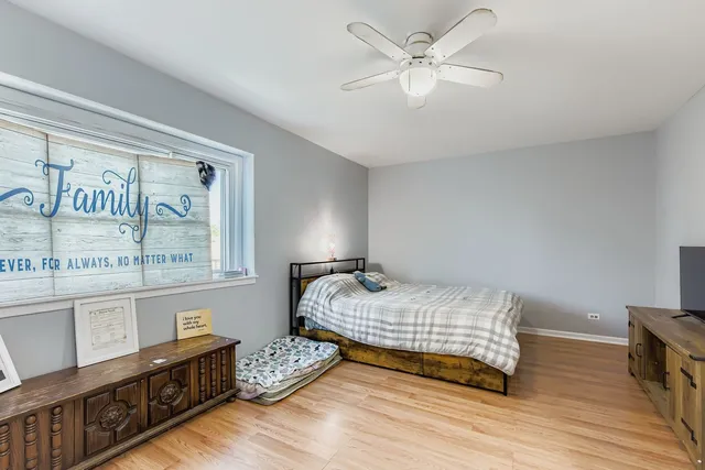 a bedroom with furniture and a wooden floor