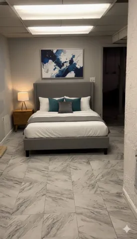 a spacious bedroom with a bed and lamp