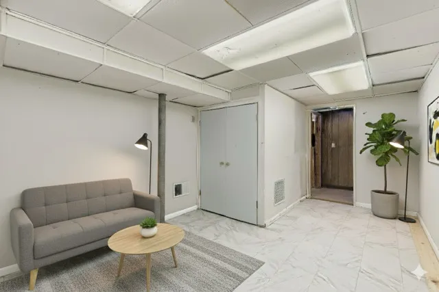 a living room with furniture and a potted plant