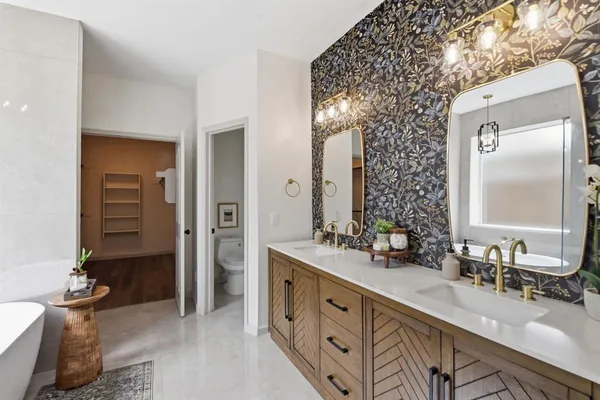 a spacious bathroom with double vanity and a mirror