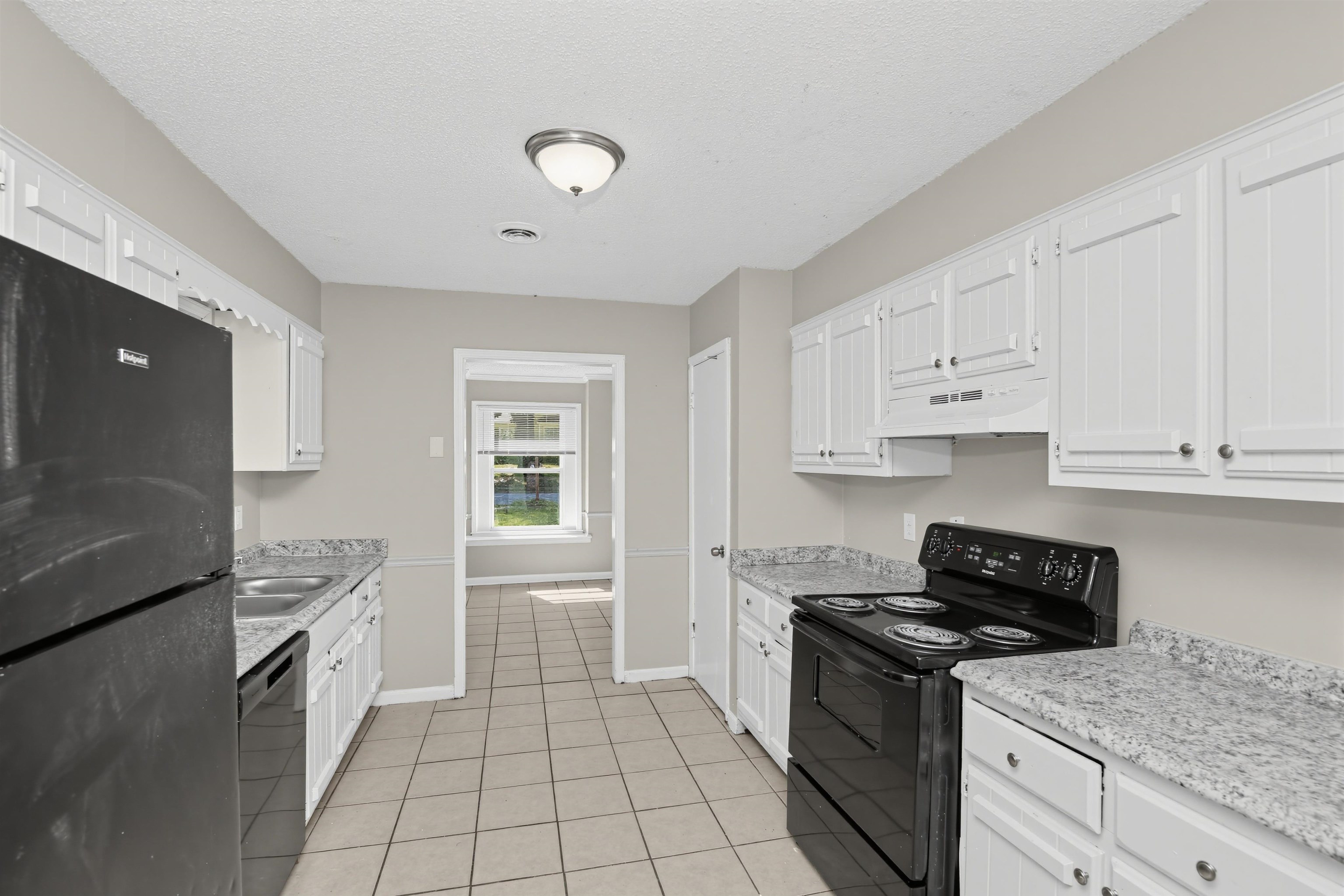 6350 Midsummer Way Memphis, TN 38115 - Photo 9 of 21 Kitchen featuring extensive white cabinetry, tile flooring, and light-toned countertops