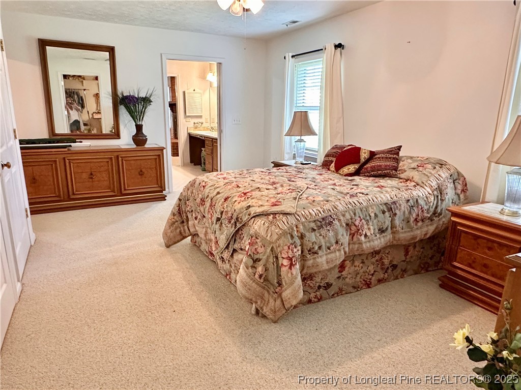 815 Whispering Pines Road Fayetteville, NC 28311 - Photo 12 of 38 a spacious bedroom with a bed and window