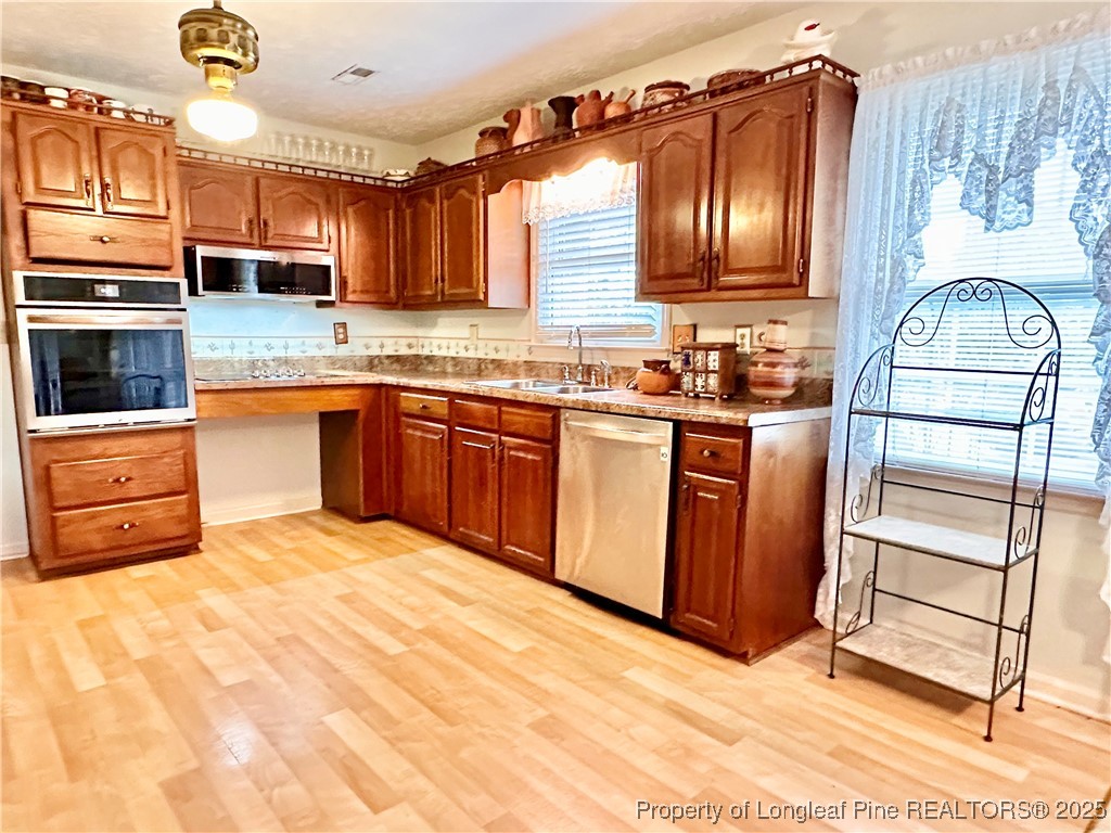 815 Whispering Pines Road Fayetteville, NC 28311 - Photo 16 of 38 a kitchen with stainless steel appliances granite countertop a stove a sink and a microwave