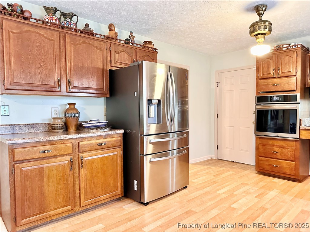 815 Whispering Pines Road Fayetteville, NC 28311 - Photo 17 of 38 a kitchen with stainless steel appliances granite countertop a refrigerator a stove and a sink