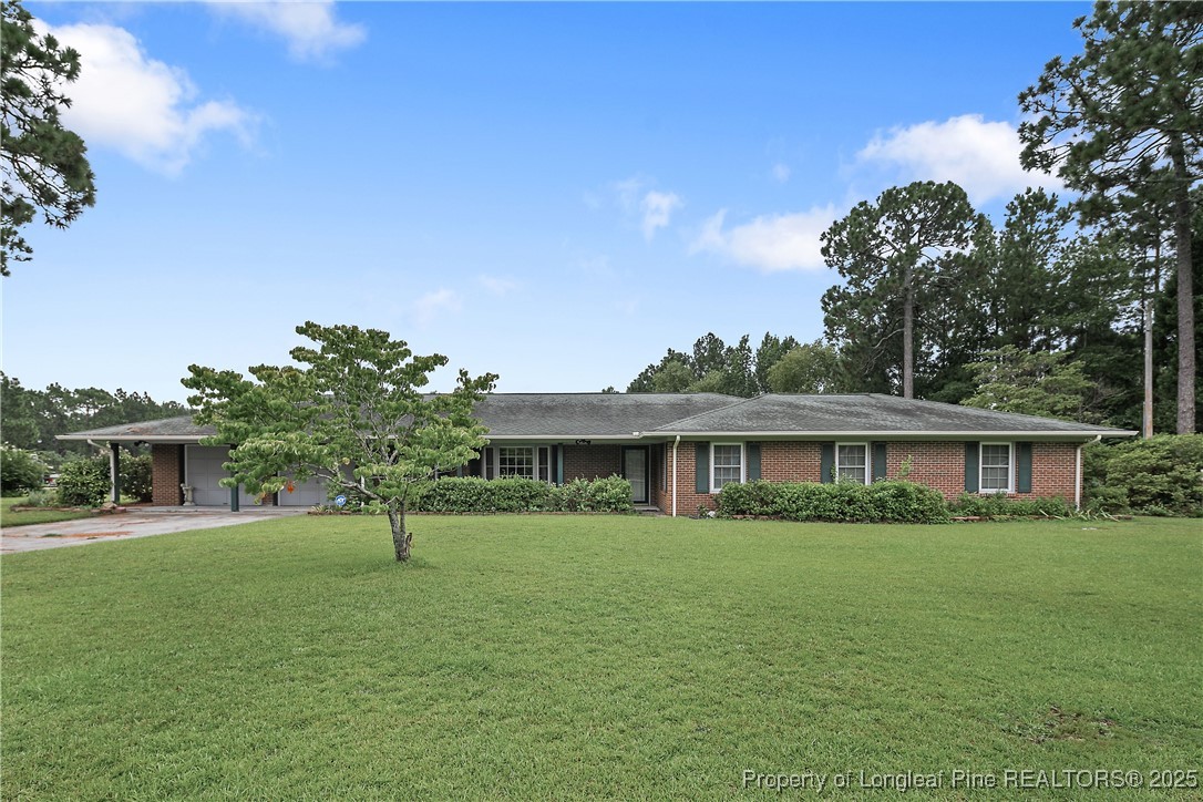815 Whispering Pines Road Fayetteville, NC 28311 - Photo 2 of 38 a front view of a house with a yard