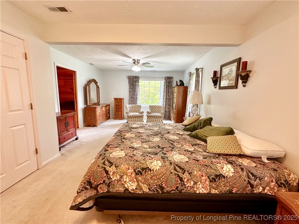 815 Whispering Pines Road Fayetteville, NC 28311 - Photo 21 of 38 a bedroom with a bed and wooden floor