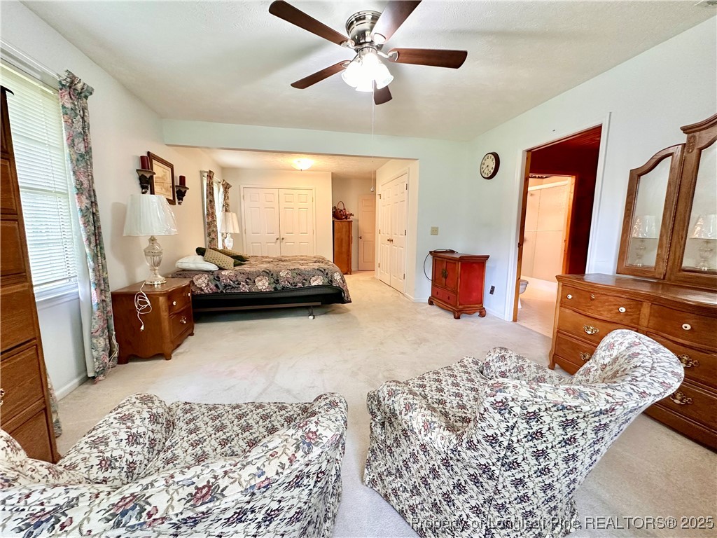 815 Whispering Pines Road Fayetteville, NC 28311 - Photo 22 of 38 a bedroom with a bed and wooden floor