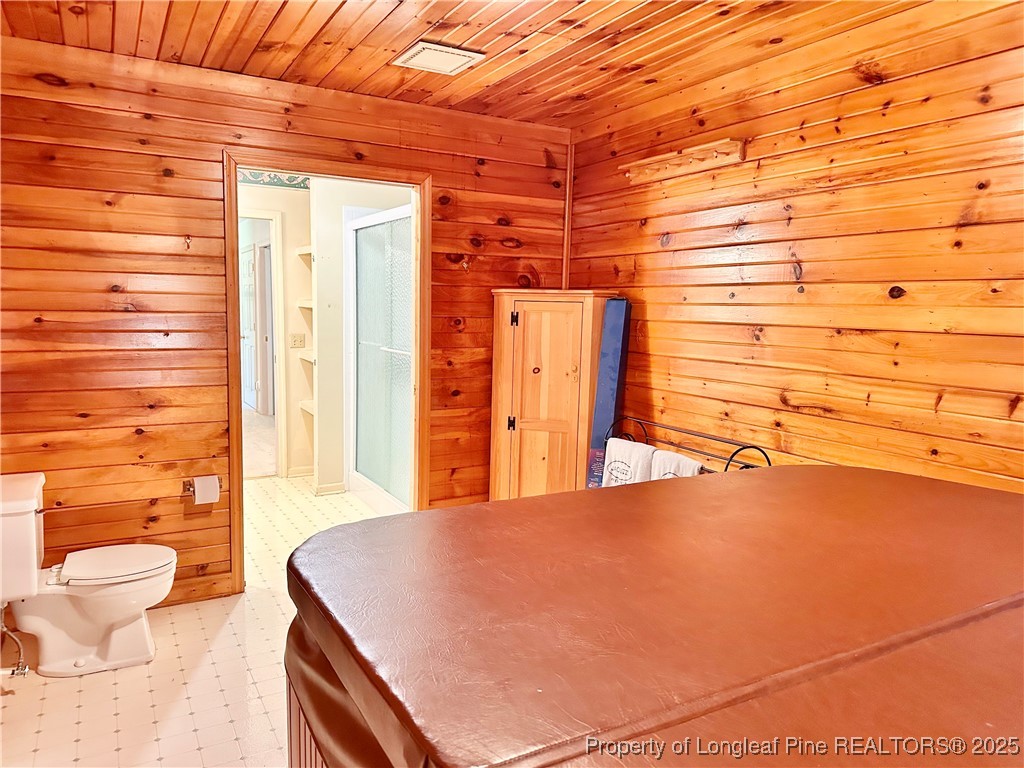 815 Whispering Pines Road Fayetteville, NC 28311 - Photo 24 of 38 a spacious bedroom with a bed and a shower