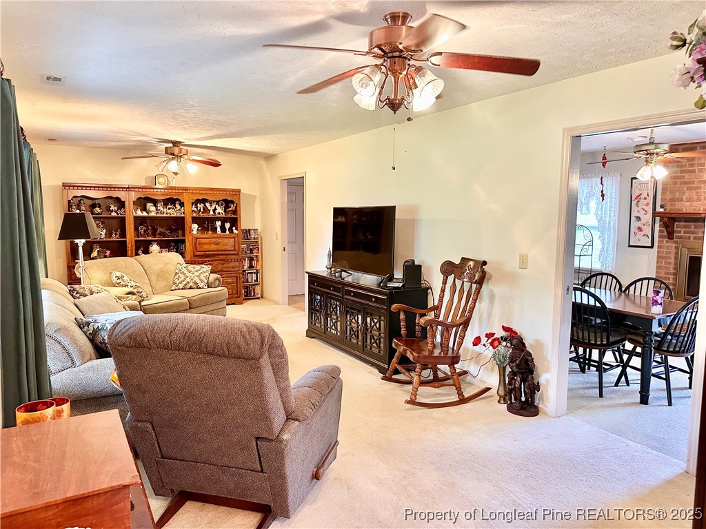 815 Whispering Pines Road Fayetteville, NC 28311 - Photo 28 of 38 a living room with furniture a flat screen tv and a window