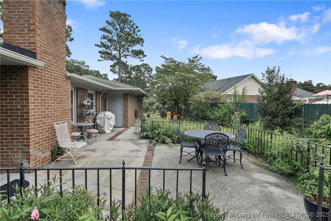 815 Whispering Pines Road Fayetteville, NC 28311 - Photo 34 of 38 a view of house with a patio and garden