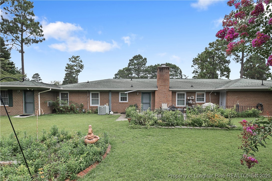 815 Whispering Pines Road Fayetteville, NC 28311 - Photo 35 of 38 a front view of a house with garden