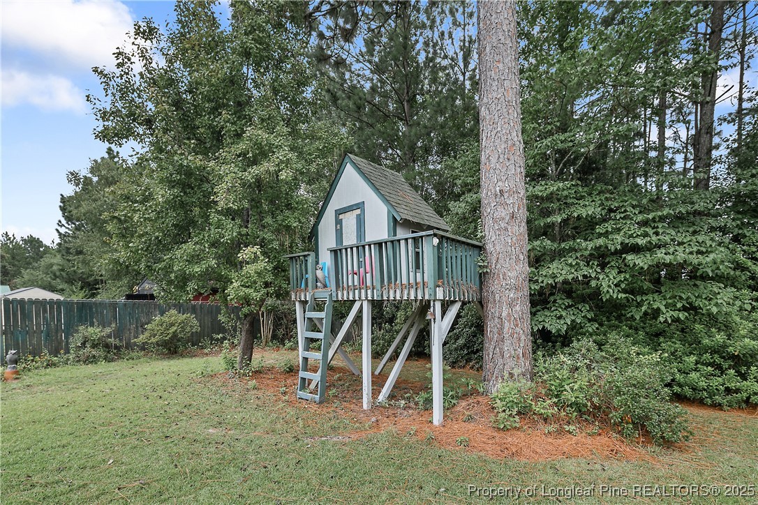 815 Whispering Pines Road Fayetteville, NC 28311 - Photo 38 of 38 a view of a wooden deck with a tree