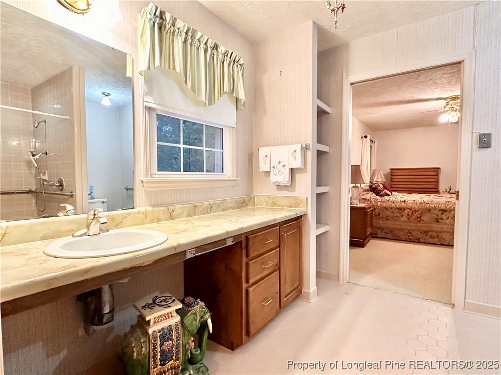 815 Whispering Pines Road Fayetteville, NC 28311 - Photo 9 of 38 a en suite bathroom with a sink double vanity