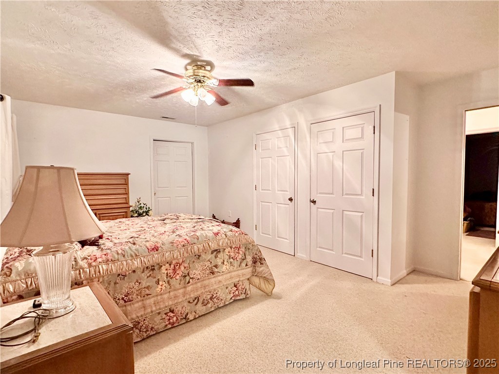 815 Whispering Pines Road Fayetteville, NC 28311 - Photo 10 of 38 a bedroom with a bed and a flat tv screen