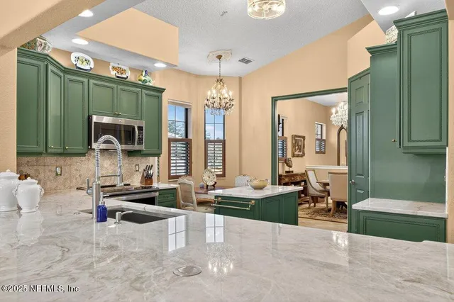 a kitchen with sink refrigerator and window