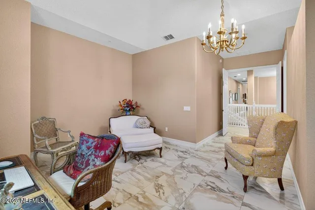 a view of a backyard with plants and outdoor seating