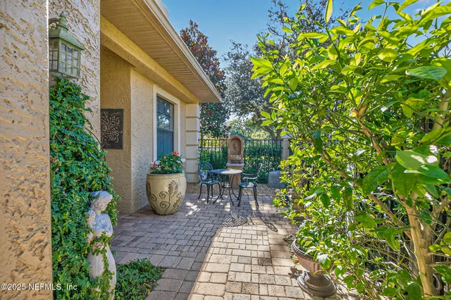 a view of a chair and table in backyard of the house