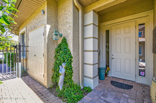 a dining room with furniture a chandelier and wooden floor